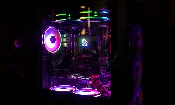 Colorful bright led rgb pc fan air case cooler in white desktop computer chassis. gaming modding water cooling and technology concept background